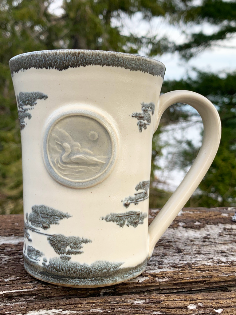 15 oz hand-thrown pottery mug with birch bark glaze and a swimming loon seal.