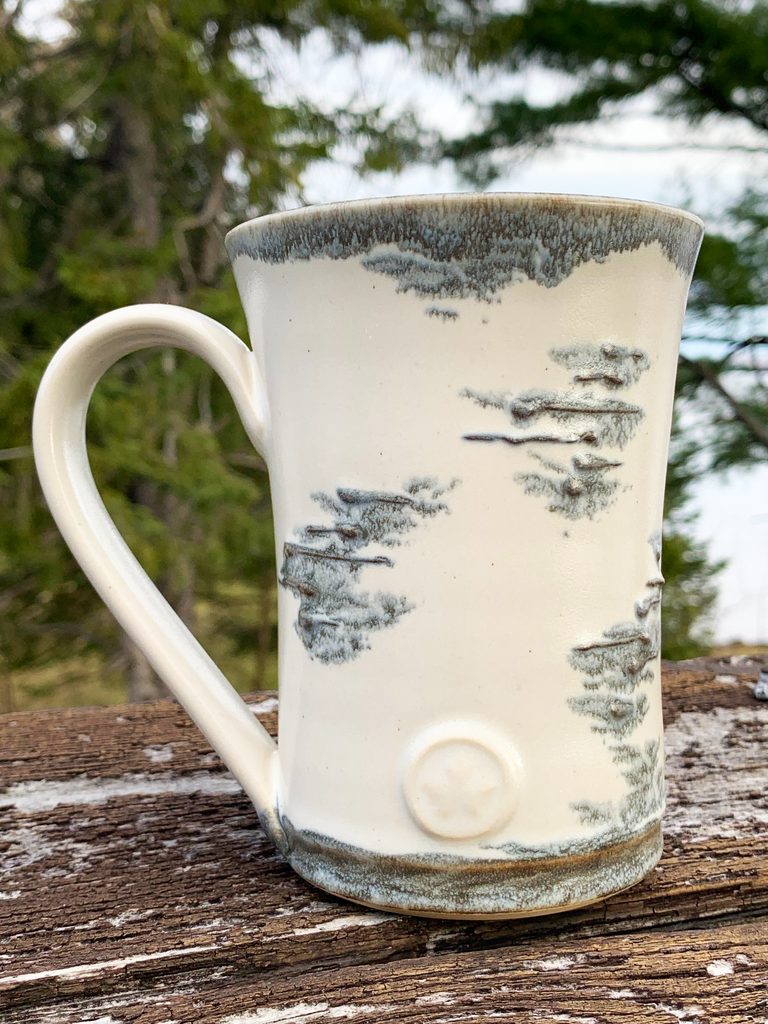 15 oz hand-thrown pottery mug with birch bark glaze and a maple leaf seal.
