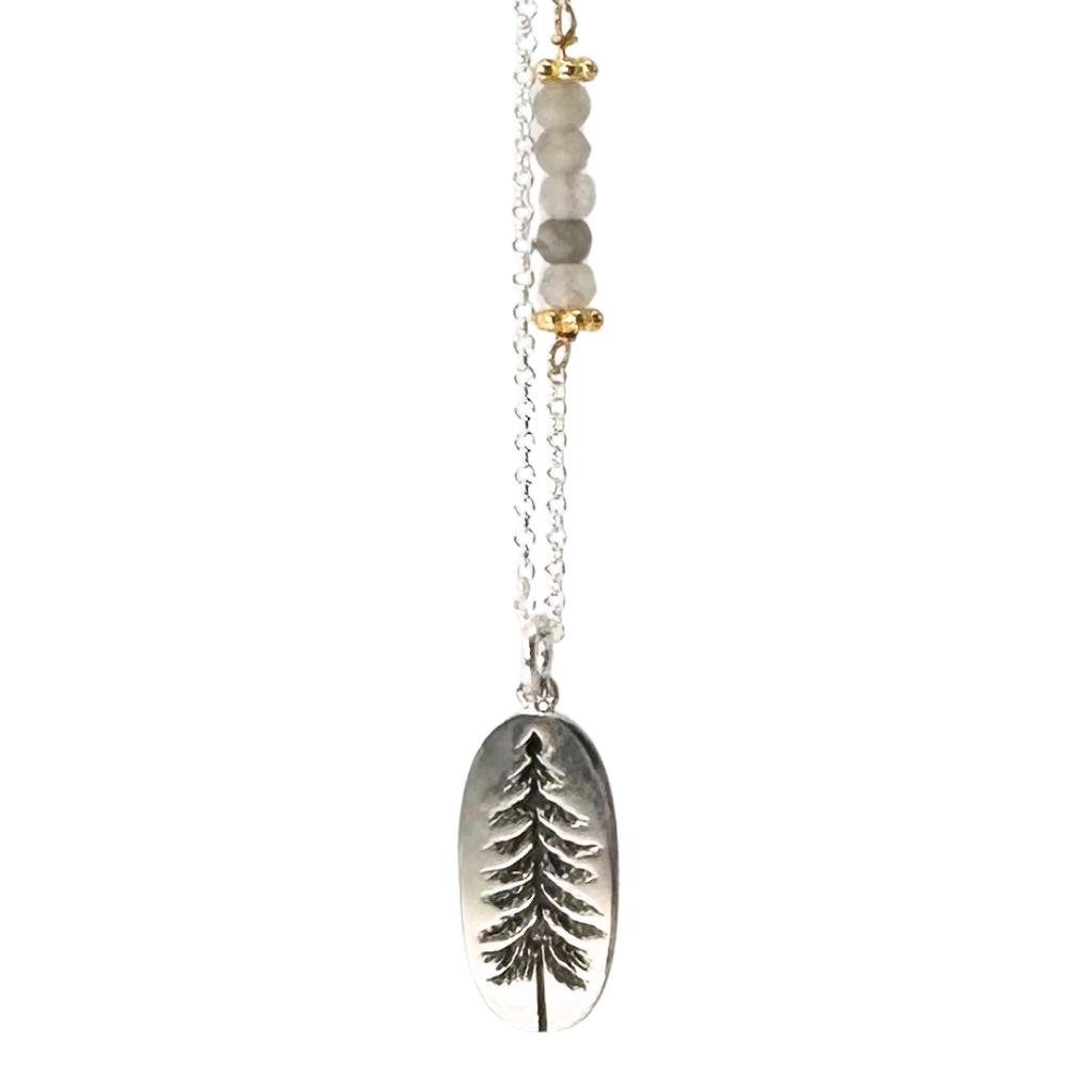 Silver chain with 5 coloured beads in middle of chain attached with gold chain links that look like flowers. Pendent is a silver oval with an indent of a pine tree. The indent of the pine tree is black.