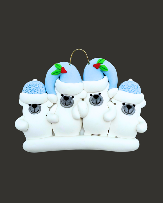 Ornament of four polar bears, two adults and two kids, wearing blue hats on a black background.