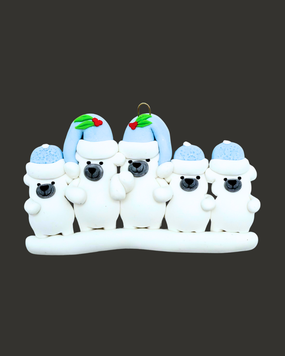 Ornament of five polar bears, two adults and three kids, wearing blue hats on a black background.