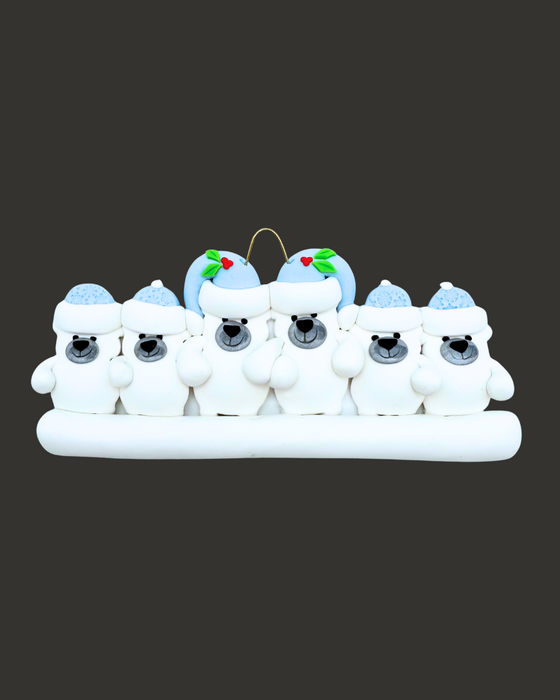 Ornament of six polar bears, two adult and four kids, wearing light blue hats on a black background.