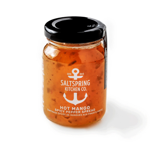 Canadian made hot mango spicy pepper spread in a clear jar with black lid.