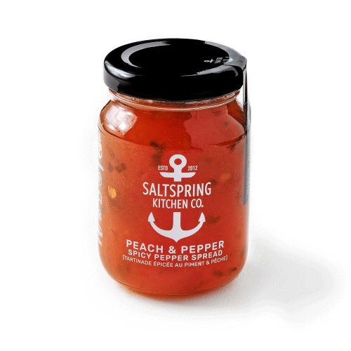 Canadian made peach and pepper spicy spread in a clear jar with black lid.