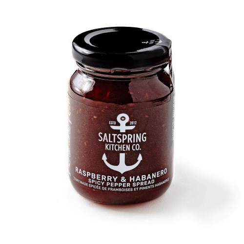 Canadian made raspberry and habanero spicy pepper spread in a clear jar with black lid.