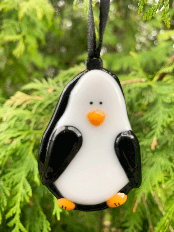A cute and loveable penguin ornament made from fused glass. This Canadian made piece is black, white, and orange. 
