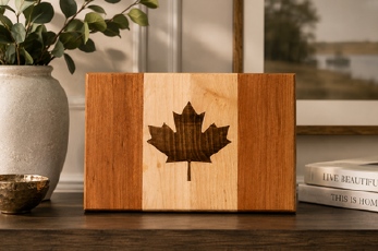 Canadian flag serving board made from maple and cherry wood with engraved maple leaf, handcrafted in Ontario, Canada.