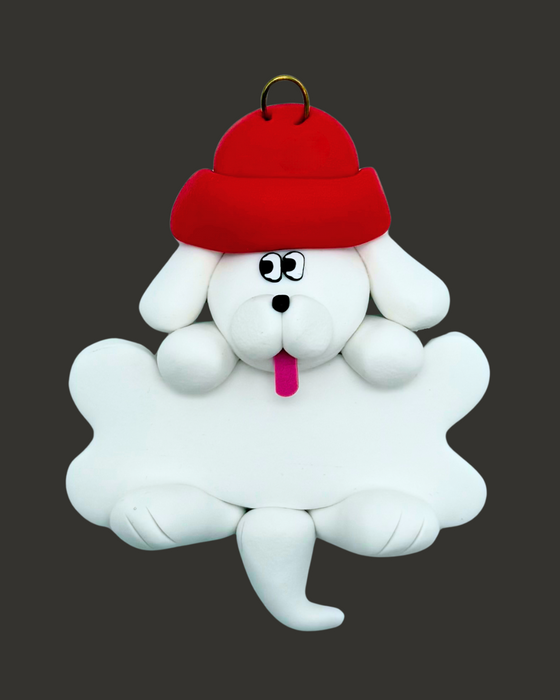 White dog ornament with a bone wearing a red hat on a black background.
