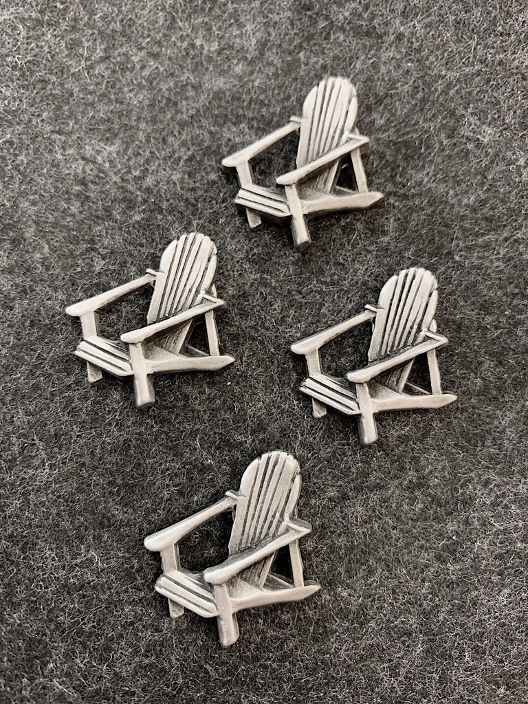 Four pewter magnets in the shape of muskoka lounge chairs. 