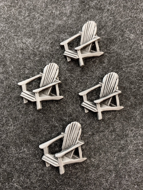 Four pewter magnets in the shape of muskoka lounge chairs. 