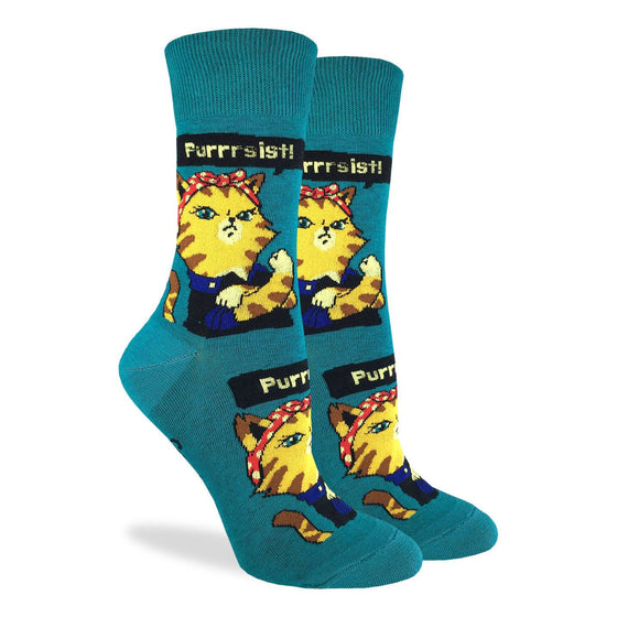 These fun socks feature an image of Rosie the Riveter as a tabby cat with the phrase “Purrsist” above. This image is on a background of teal. Spandex added to the 85% cotton blend gives the socks the perfect amount of stretch to hug your feet.