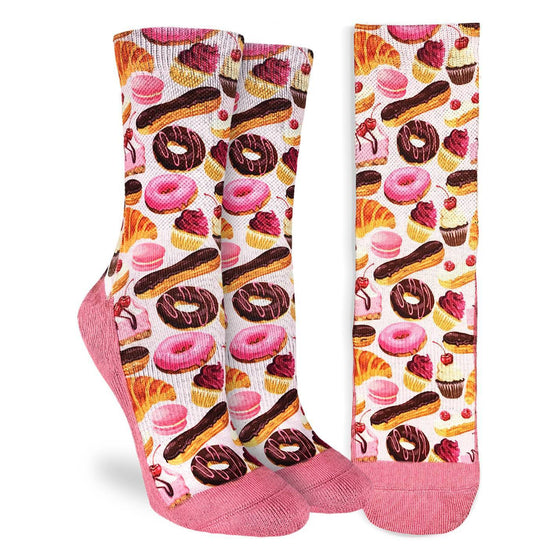 These fun socks feature tasty pastries such as donuts, cupcakes, croissants, and snickerdoodles, on a light pink background.  The sole, toe, and heel, of the sock are a deeper pink. The active fit socks sport elastic arch bands to contour to your feet and provide support.