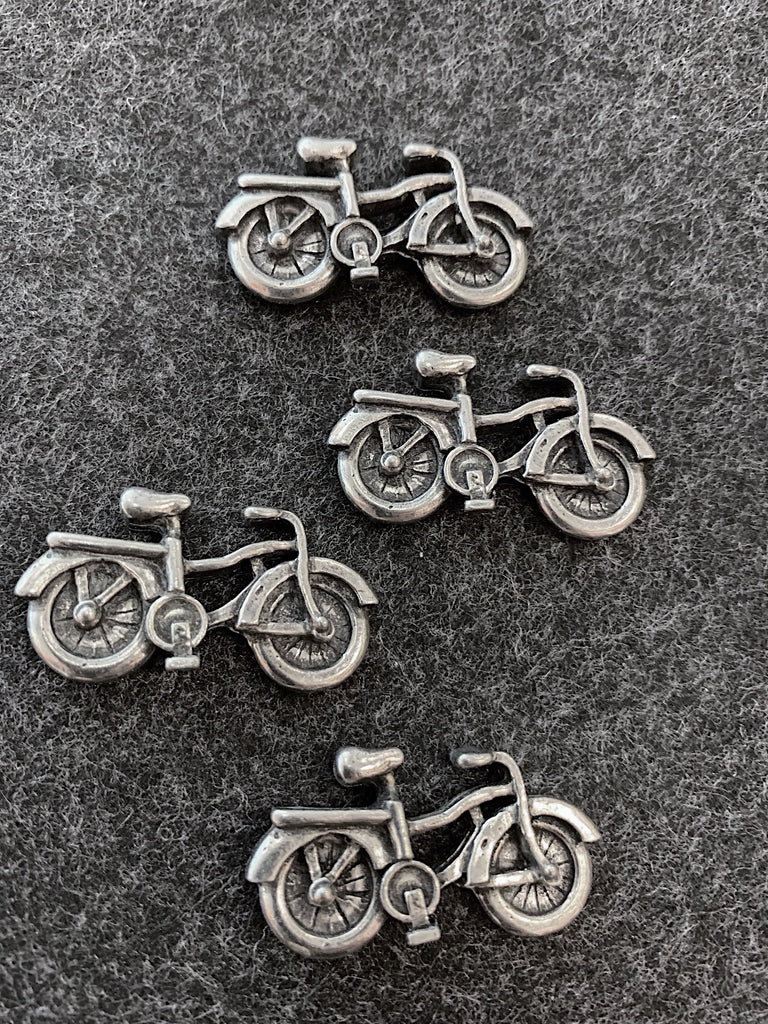 This set of magnets features four bicycles with top wheel covers and a cargo racks over the rear wheels. 