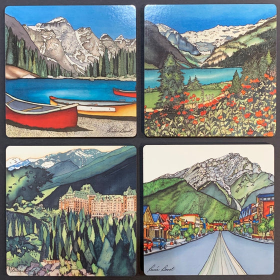 This set of coasters features four unique prints of Banff. One shows three canoes docked by Lake Moraine with the Canadian Rockies in the background. One shows the Banff Springs Hotel on a lush green hill. One shows a field of orange flowers near the emerald Lake Louise. One shows the colourful storefronts on Banff Avenue with the Rockies in the background. The pictures are richly coloured. The artist’s signature is at the bottom of each coaster.