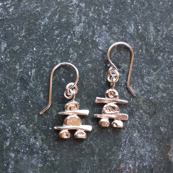 Two sterling silver Inukshuk hook earrings. Each handmade Inukshuk is unique and shaped slightly different than each other.