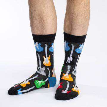 These fun socks feature red, yellow, green, blue, and grey guitars with white necks standing upright on a black background that makes the guitars pop. Spandex added to the 85% cotton blend gives the socks the perfect amount of stretch to hug your feet.