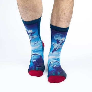 These fun socks feature three white and grey fighter jets high in the Earth’s atmosphere. At the bottom of the image is a close up of a pilot with a high altitude helmet on. Two more jets fly on a background of the Earth and the Moon in the distance. The sole and back of the sock is a dark blue, while the toe and heel is red. The active fit socks sport elastic arch bands to contour to your feet and provide support.