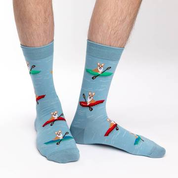 Calling all corgi lovers! These socks' design features corgis in kayaks, on the water. These socks are light blue with water ripples. How can you resist petting a cute kayaking corgi? This sock print is perfect for the dog-loving outdoor enthusiast. These socks are sure to complement your next dog-park adventure outfit.