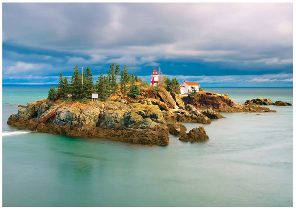 This puzzle features Campobello Island in New Brunswick and features blue cloudy skies, turquoise blue water and a red and white lighthouse.