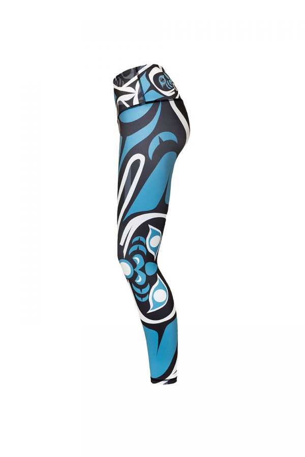 The wolf leggings viewed from the left. This angle provides a clear view of the large teal and white moon on the left leg.