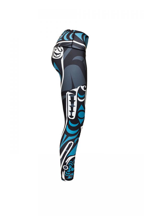 The wolf leggings viewed from the right. This angle displays the wolf. Its outline is in white and its fur and eyes are teal. It is baring its teeth. At the base of the right leg is another small teal moon.