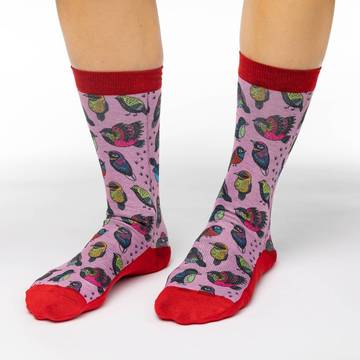 These cute socks will decorate your feet with several cute and colorful tropical birds in a neo-traditional art style. The sock background is a soft pink while the cuff and heel through to the toe is a vibrant scarlet. 48% Polyester, 45% Cotton, 5% Elastic, 2% Spandex