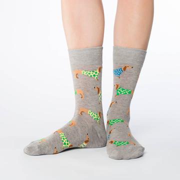 These fun socks feature brown wiener dogs wearing blue and green sweaters with white dots, on a background of grey. Spandex added to the 85% cotton blend gives the socks the perfect amount of stretch to hug your feet.