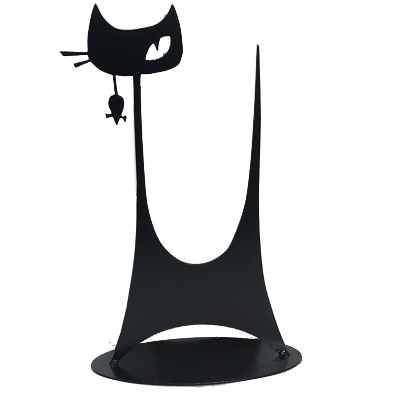 This metal sculpture shows the matte black silhouette of a highly stylized cat. It has a tall thin tail and large head on a tall thin neck. It has two whiskers and a single, cunning right eye.  A small mouse dangles from the cat’s mouth. The piece stands on a oval base.