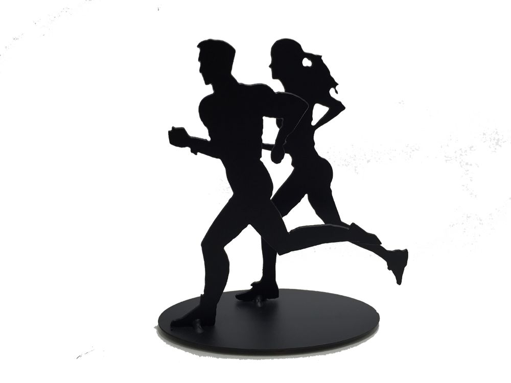This metal sculpture shows the matte black silhouette of one male and one female figure running together. The female runner is slightly behind and to the right of the male. Both have one foot planted on the ground with the other in the air behind them. Both are pumping their arms as they run. The piece stands on a small oval base.