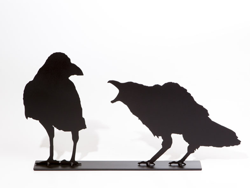 The matte black silhouette of two crows standing together. The right crow is cawing at the left crow. The right crow has a jagged outline which creates a realistic impression of ruffled feathers. The left crow seems unfazed by it crying counterpart.  