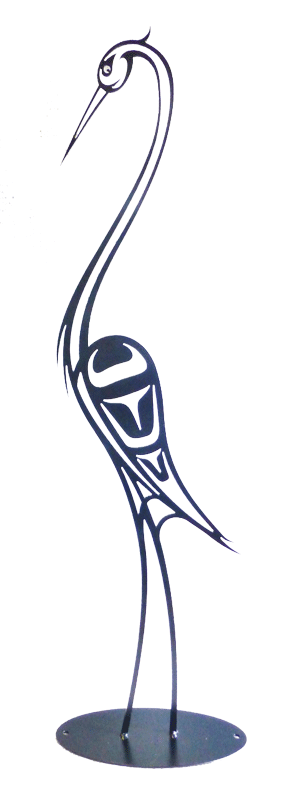 This metal sculpture shows the matte black silhouette of a heron drawn in Coastal Salish style. The heron stands tall with its beak pointing downward. Coastal Salish forms provide the details of its face and wings. It’s long neck and slender legs curve gracefully. The sculpture sits on a circular metal base.