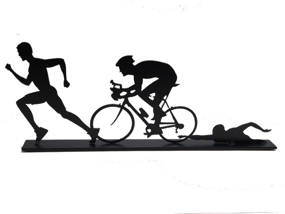 This metal sculpture shows the matte black silhouette of three male figures, each doing one trial in a triathlon. The leftmost is running, the center is biking, and the rightmost is swimming. The silhouettes slightly overlap each other. This piece sits on a narrow rectangular base.