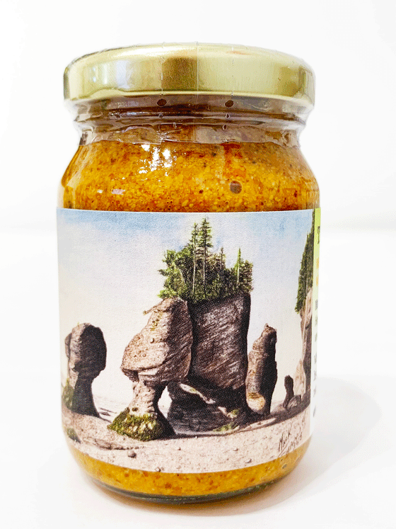 Clear jar with slightly red-tinged grainy mustard inside. Label depicts print of New Brunswick artist Mark Seamans' "The Tides."