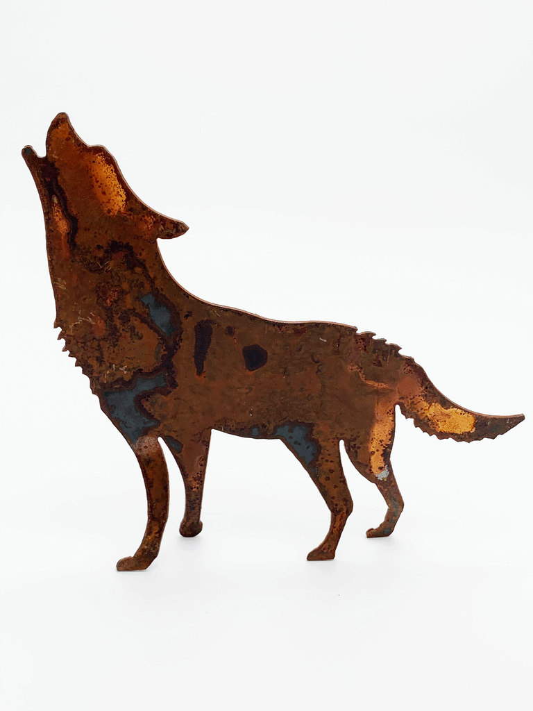 A howling wolf silhouette standing on four legs, cut from warm, weathered steel. The unique dappling of the oxidized steel makes each piece one-of-a-kind.