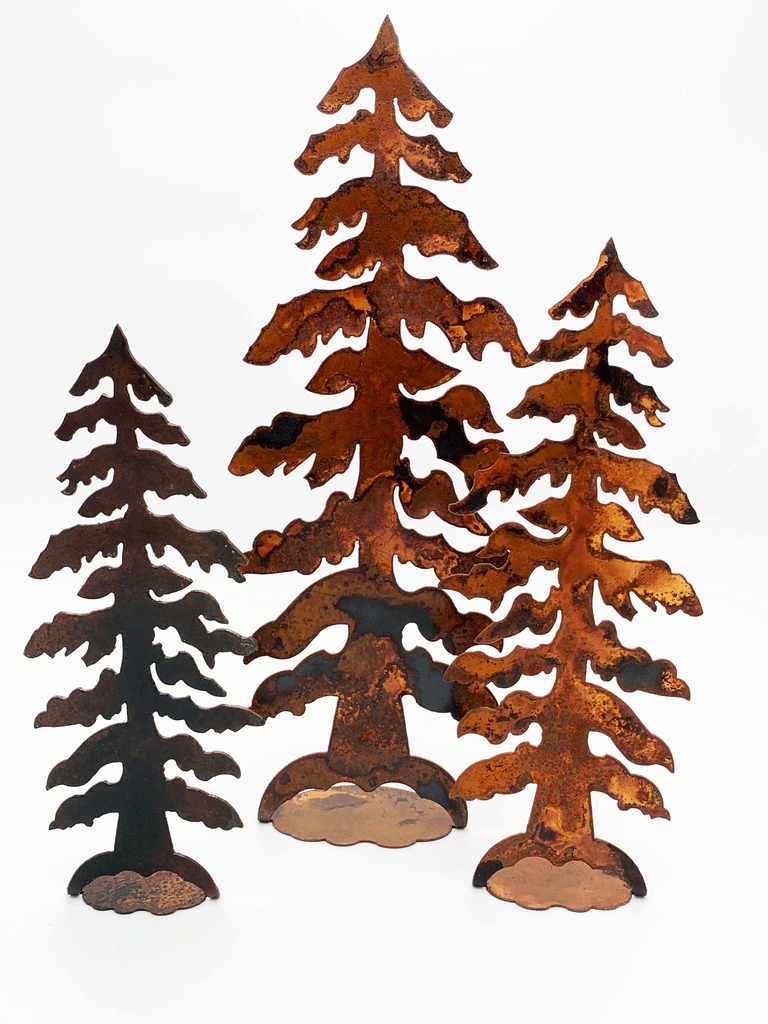 Three draping pine trees of different sizes, each cut from warm, weathered steel. The roots attach to sturdy bases.