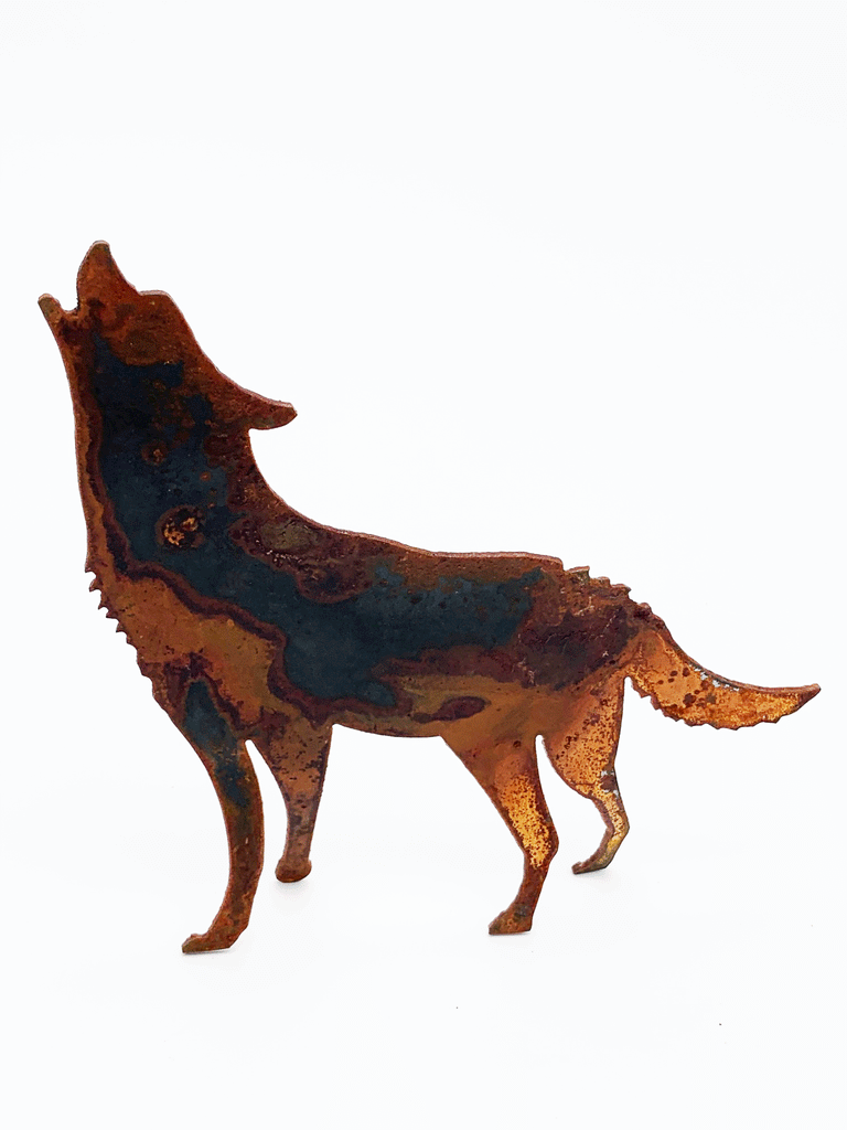 A howling wolf silhouette standing on four legs, cut from warm, weathered steel. The unique dappling of the oxidized steel makes each piece one-of-a-kind.