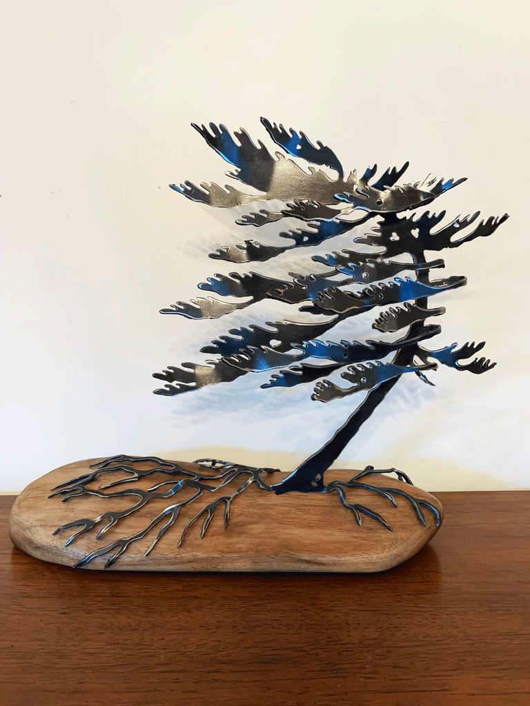 Steel windswept pine tree fitted onto a piece of Canadian polished wood. 