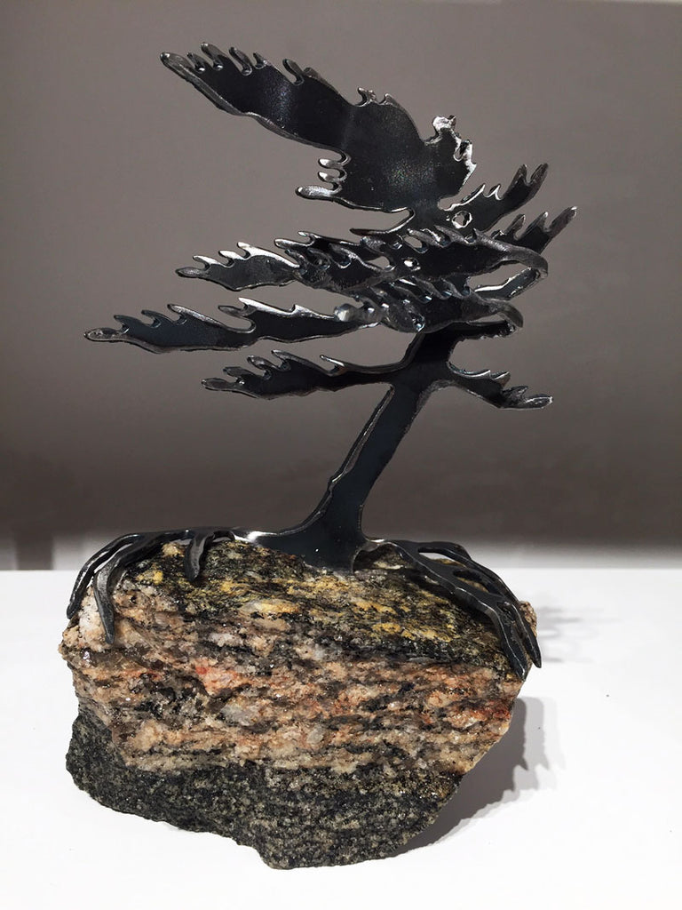Steel windswept pine tree fitted onto a piece Canadian stone. 