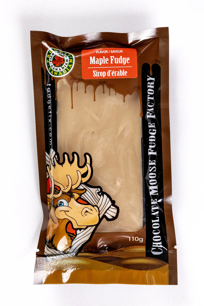 Rectangular Fudge Bar made in Canada Inside of a plastic package. There is a cartoon Moose on the cover of the package, and big writing saying 'Chocolate Moose Fudge Factory'. Flavor of the fudge is Maple. Fudge is Light brown colour.