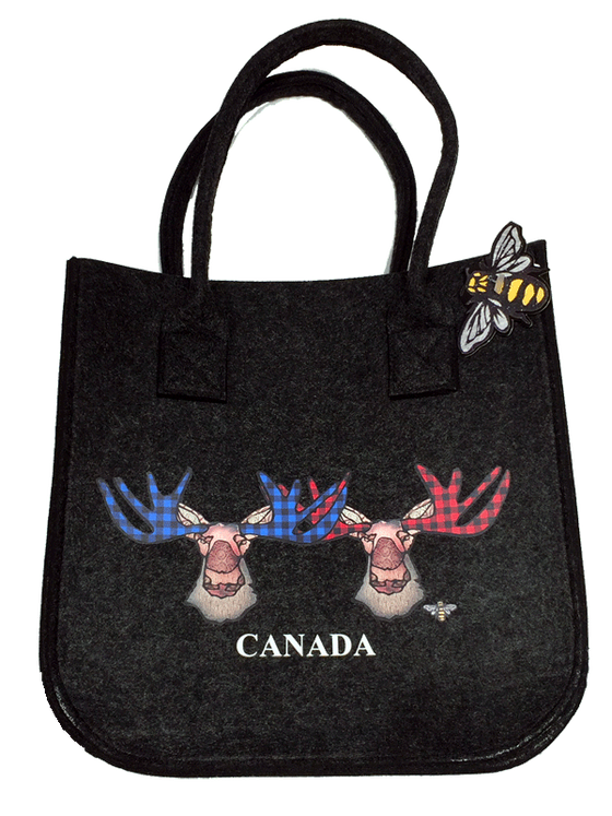 A medium charcoal tote bag with two moose side by side. One has antlers in blue plaid, the other in red plaid. The bag says CANADA on the bottom