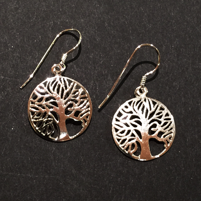 Two sterling silver tree earrings sit on a black background. The trees are contained within hoops. The trees’ numerous thin branches radiate outward and fuse with the outer hoops. A silver earring hook attaches to the top of each hoop.