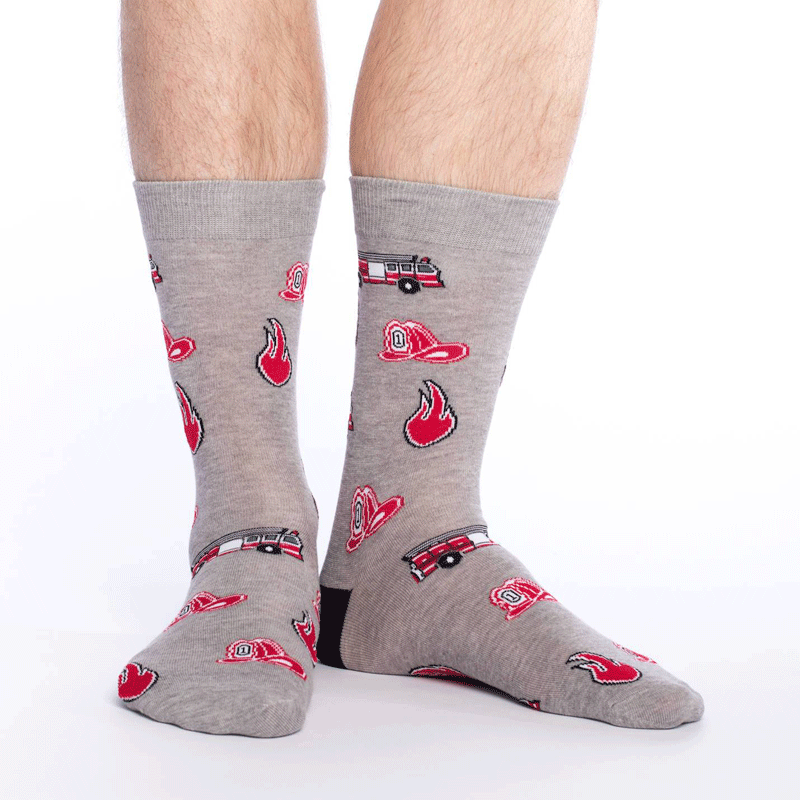 These fun socks feature cartoon images of a fire, a fireman's hat, and a fire truck on a background of light dappled grey with a black heel. Spandex added to the 85% cotton blend gives the socks the perfect amount of stretch to hug your feet.