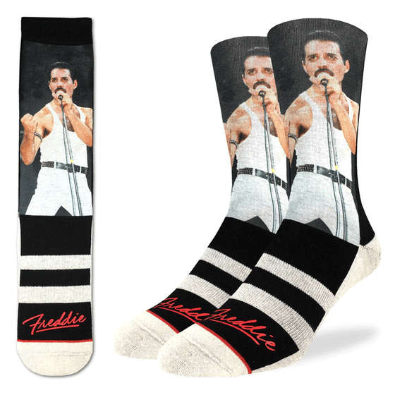 These fun socks feature a photo of Freddie Mercury performing at the concert Live Aid in 1985. He stands at the mic in white jeans and tank top and his hand in a fist. Below the photo is black with two white stripes, and his signature is printed in red near the toe. The sole, heel, and toe of the sock are white. The active fit socks sport elastic arch bands to contour to your feet and provide support.