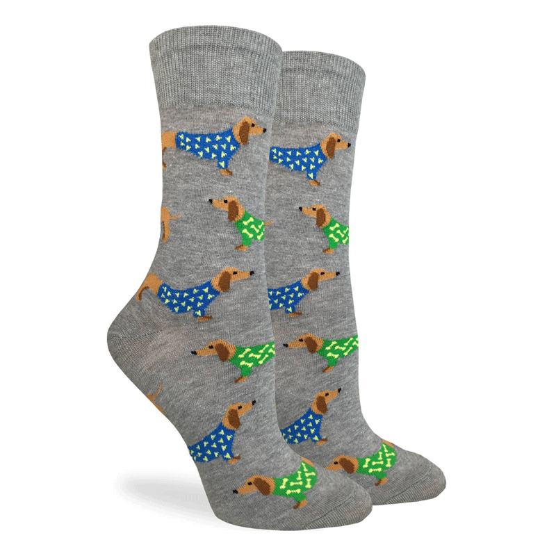 These fun socks feature brown wiener dogs wearing blue and green sweaters with white dots, on a background of grey. Spandex added to the 85% cotton blend gives the socks the perfect amount of stretch to hug your feet.
