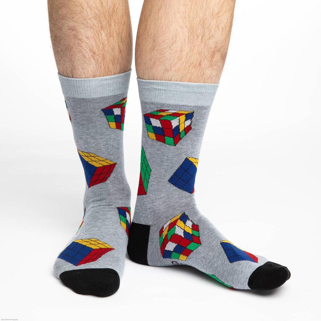 These fun socks feature Ribkic’s cubes, completed and mixed up, on a speckled grey background with a lighter grey rim, and black toe and heel. Spandex added to the 85% cotton blend gives the socks the perfect amount of stretch to hug your feet.