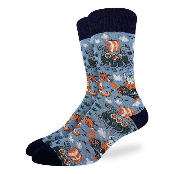 These fun socks feature viking sailing ships, great red dragons spitting fire at vikings sporting great red beards, round shields, and horned helmets on a light blue background. The toe, heel, and rim of the sock are black. Spandex added to the 85% cotton blend gives the socks the perfect amount of stretch to hug your feet.