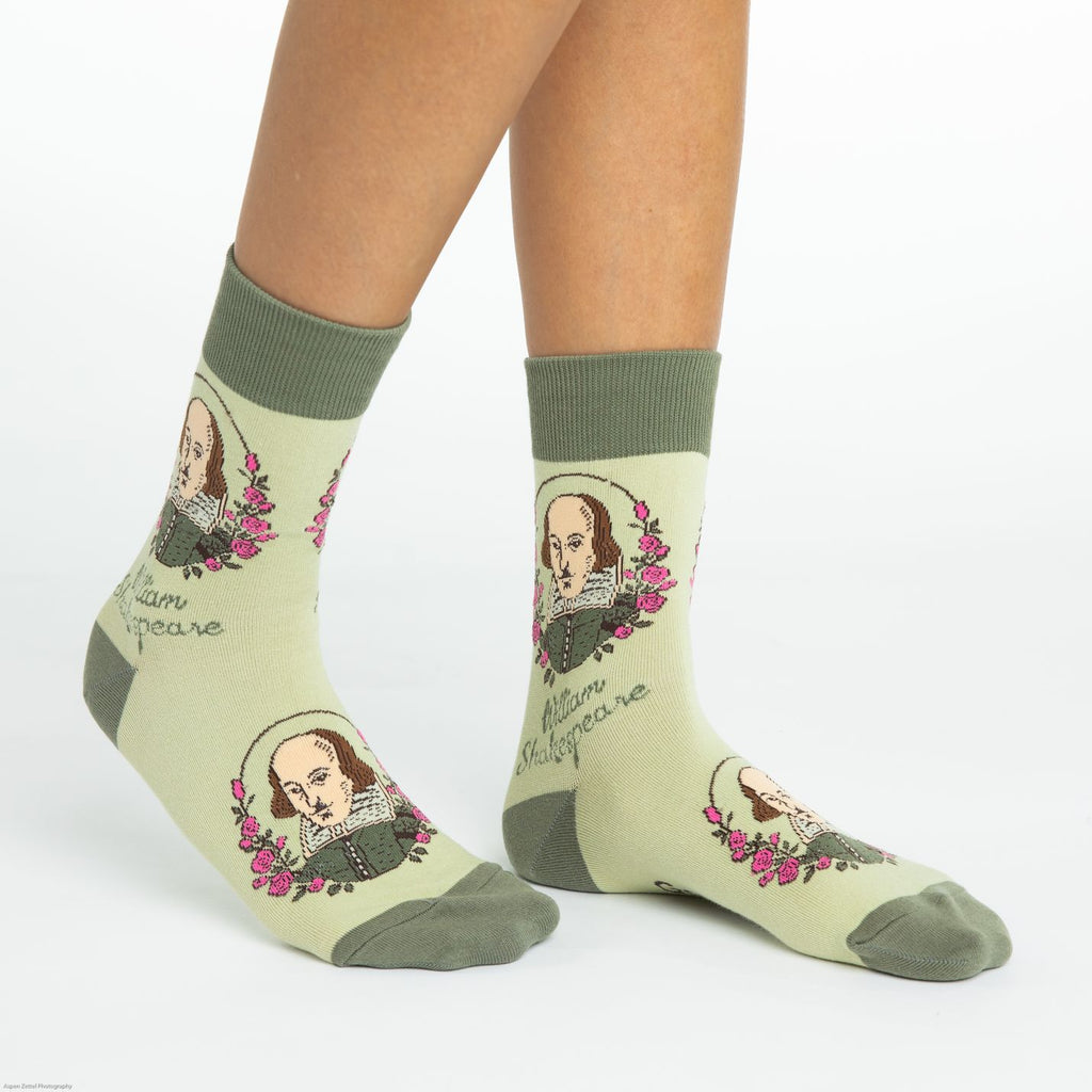 These fun socks feature an image of William Shakespeare with roses to the left and right of him and his name underneath. This image is on a background of a light green with a darker green toe, heel, and rim. Spandex added to the 85% cotton blend gives the socks the perfect amount of stretch to hug your feet.