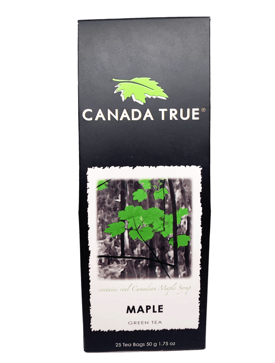 Black rectangular tapered box. Photo of trees in black and white with only a few leaves being green. Text says “Contains real Canadian maple syrup” in light green cursive font. Followed by the label of “Maple Green Tea.”