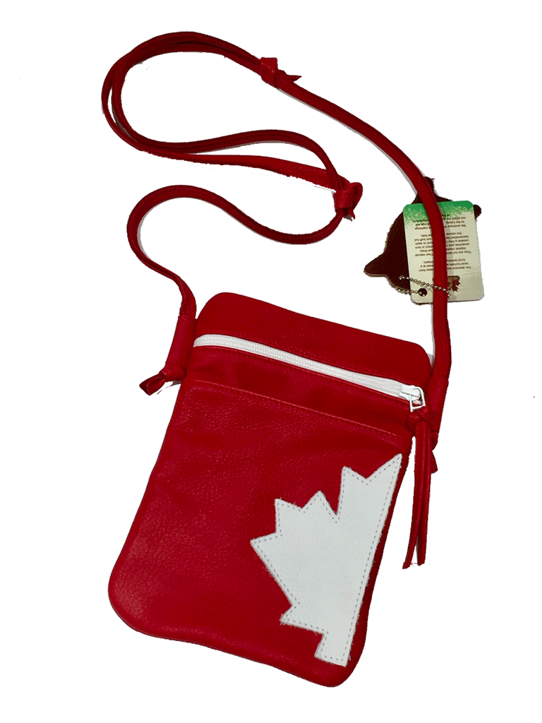 A red leather shoulder bag with half of a white maple leaf sewn onto the right side. The bag has a long adjustable leather shoulder strap. Across the top of the front of the bag is a white zipper with a red pull tab. The leather looks soft but sturdy.
