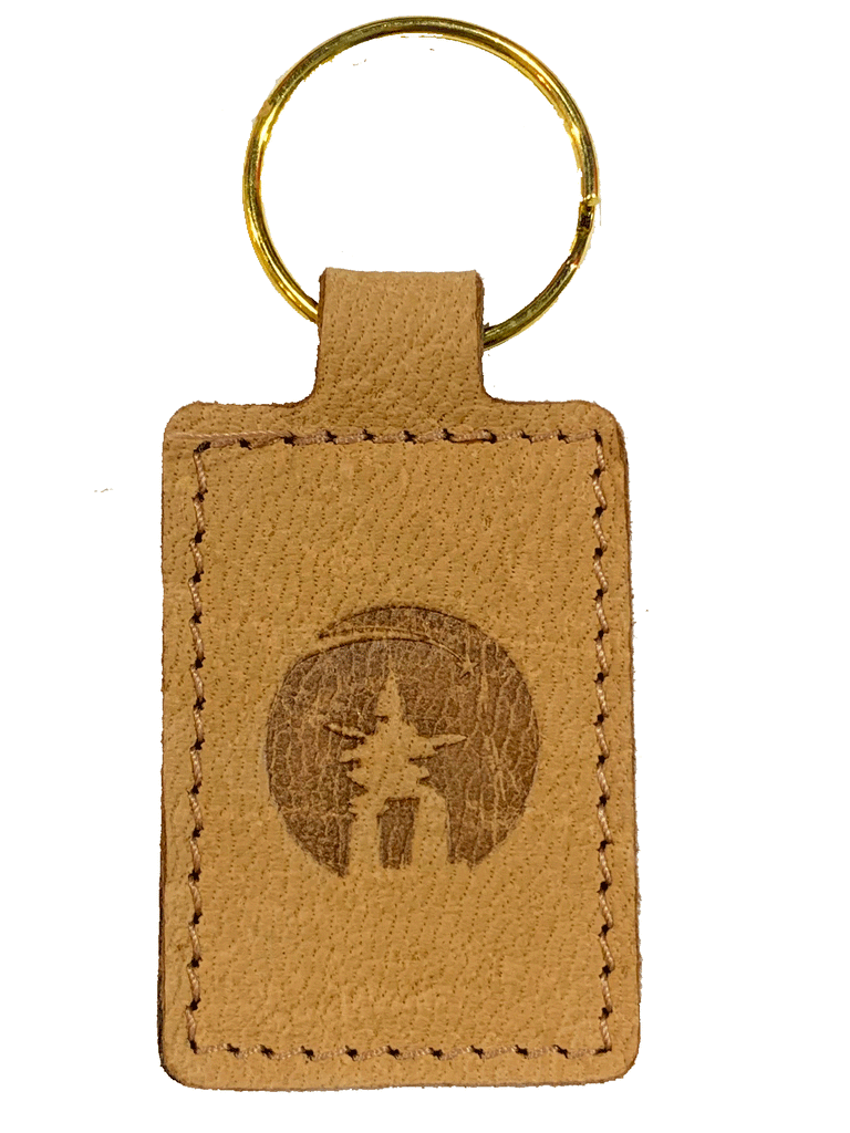 Beige leather sealskin key ring with inukshuk embossing in the centre. 